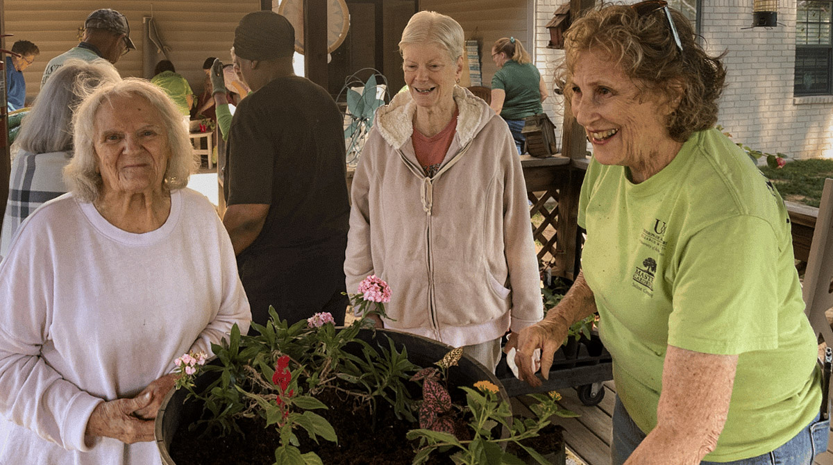 Saline County Master Gardeners helping memory care residents plant spring flowers at Southern Trace Rehabilitation and Care Center in Bryant, Arkansas.